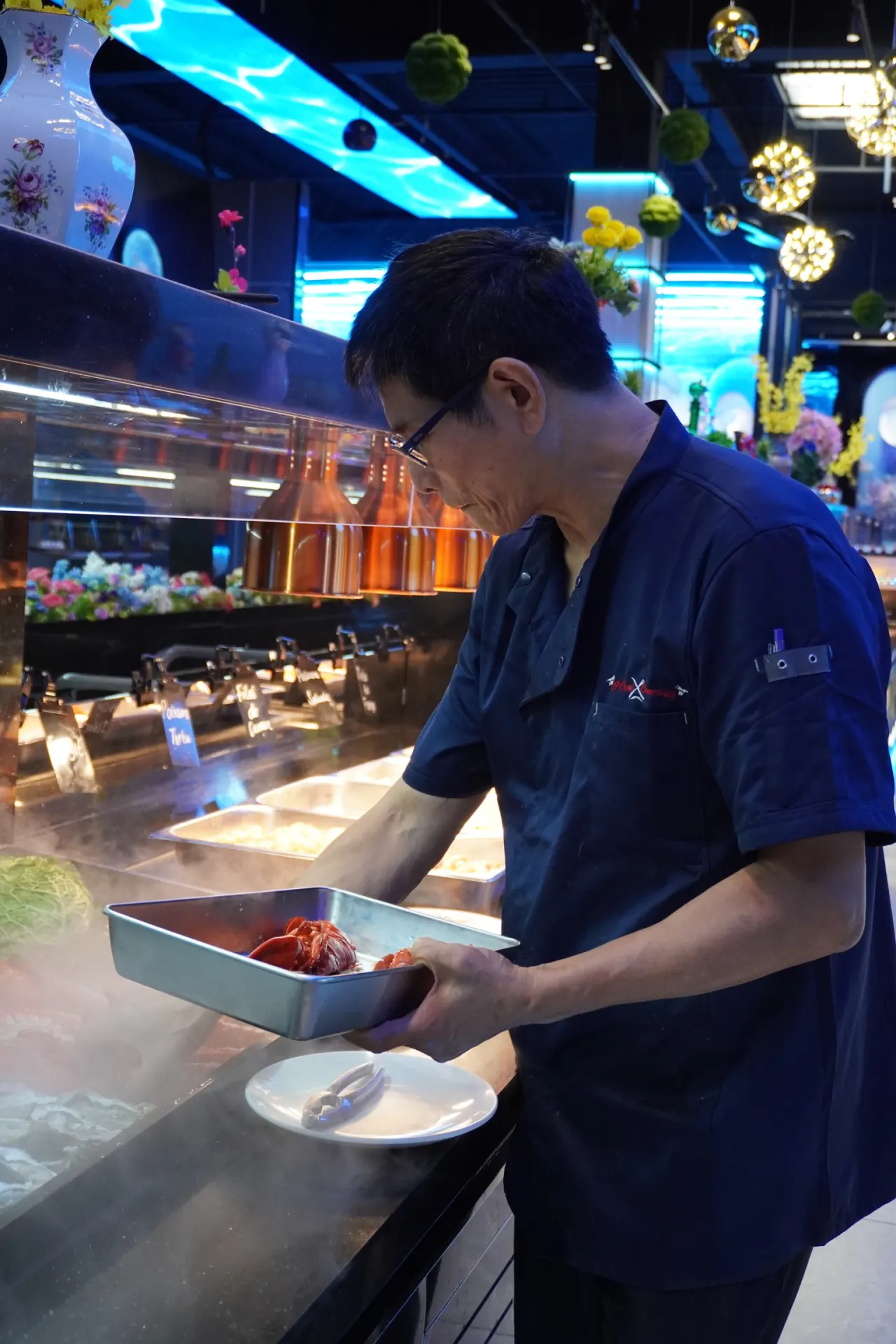 Chef en action devant le buffet de fruits de mer